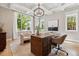 Bright office space with hardwood floors, a large window, coffered ceilings, and custom lighting at 115 S Glencoe, Denver, CO 80246