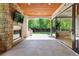 Covered patio with stone fireplace, outdoor grill, and seamless access to indoor spaces at 115 S Glencoe, Denver, CO 80246