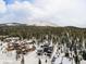 Panoramic aerial view of mountain neighborhood with snow-covered homes surrounded by evergreen trees under cloudy sky at 436 N Fuller Placer Rd, Breckenridge, CO 80424