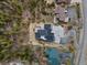 An aerial view of a modern home with unique architectural design and large driveway surrounded by lush trees at 436 N Fuller Placer Rd, Breckenridge, CO 80424