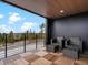 Cozy outdoor seating on a covered balcony with scenic views of the forest and mountains at 436 N Fuller Placer Rd, Breckenridge, CO 80424