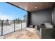 Cozy outdoor balcony with comfortable seating, wooden flooring, and peaceful snowy forest view at 436 N Fuller Placer Rd, Breckenridge, CO 80424