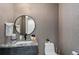 Stylish powder room featuring modern wallpaper and a round mirror at 436 N Fuller Placer Rd, Breckenridge, CO 80424