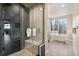 Modern bathroom featuring an enclosed shower and large tub with an outdoor view at 436 N Fuller Placer Rd, Breckenridge, CO 80424