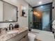 An updated bathroom with a granite countertop, modern vanity, shower and tub combination, and tiled walls at 436 N Fuller Placer Rd, Breckenridge, CO 80424