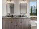 Elegant bathroom with double vanity, granite countertops and views of nature outside the window at 436 N Fuller Placer Rd, Breckenridge, CO 80424