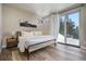 Cozy bedroom with snowy mountain views, featuring a modern bed frame and wood floors at 436 N Fuller Placer Rd, Breckenridge, CO 80424