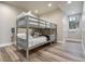 Cozy bedroom featuring a gray bunk bed with soft bedding and a view of the snowy outdoors at 436 N Fuller Placer Rd, Breckenridge, CO 80424