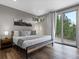 Inviting bedroom featuring hardwood floors, a large window, and access to outdoor views at 436 N Fuller Placer Rd, Breckenridge, CO 80424
