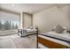 Bright bedroom featuring two twin beds, a large window, and a stylish patterned rug at 436 N Fuller Placer Rd, Breckenridge, CO 80424