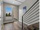 A modern home entryway with a view of the outdoors, a unique staircase, and wood floors at 436 N Fuller Placer Rd, Breckenridge, CO 80424
