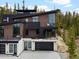 An eye-level view of a modern exterior showcasing its architectural features, balconies, and mountain views at 436 N Fuller Placer Rd, Breckenridge, CO 80424