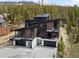Contemporary home with sleek design, balconies, three-car garage, and mountain views nestled in the forest at 436 N Fuller Placer Rd, Breckenridge, CO 80424