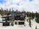 Stylish home with a modern design and expansive windows, blending seamlessly into a snowy, wooded landscape at 436 N Fuller Placer Rd, Breckenridge, CO 80424