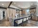 Open kitchen with wood cabinets, granite counters, and a large island with bar seating at 436 N Fuller Placer Rd, Breckenridge, CO 80424