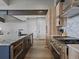 Open-concept kitchen with stainless steel appliances, island with sink, wood cabinets, and granite countertops at 436 N Fuller Placer Rd, Breckenridge, CO 80424