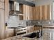Close-up of kitchen features including a stainless steel range hood, countertops, oven and wooden cabinets at 436 N Fuller Placer Rd, Breckenridge, CO 80424