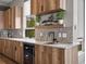 Close-up of kitchen features: granite countertops, wine cooler, dark faucet and decorative plants at 436 N Fuller Placer Rd, Breckenridge, CO 80424