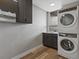 Laundry room with stacked washer and dryer, sink, storage cabinets and window at 436 N Fuller Placer Rd, Breckenridge, CO 80424
