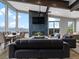 Open living room with mountain views, fireplace, stylish furniture, and floor-to-ceiling windows at 436 N Fuller Placer Rd, Breckenridge, CO 80424