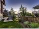 Backyard features a manicured lawn and lush garden beds at 10167 Nadine Ave, Parker, CO 80134