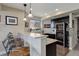Granite wet bar area with wine fridge, seating, and ample lighting, perfect for entertaining at 10167 Nadine Ave, Parker, CO 80134