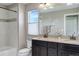 Bright bathroom features double vanity sinks, tiled shower/tub, and a large mirror at 10167 Nadine Ave, Parker, CO 80134