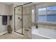 Bathroom features a glass shower and separate tub under window, tile throughout, plus modern fixtures at 10167 Nadine Ave, Parker, CO 80134