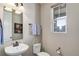 Cozy powder room featuring a pedestal sink, a window with views, and neutral wall paint at 10167 Nadine Ave, Parker, CO 80134