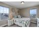 Cozy bedroom features a plaid comforter, natural lighting, and neutral wall decor at 10167 Nadine Ave, Parker, CO 80134