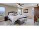 Comfortable primary bedroom showcasing a plush bed, soft carpet, and natural light from large windows at 10167 Nadine Ave, Parker, CO 80134