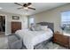 Spacious bedroom with a view, featuring soft carpet, a large bed, and natural light from the windows at 10167 Nadine Ave, Parker, CO 80134