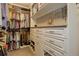 Walk-in closet boasts custom white shelving, drawers, and hanging rods for optimal storage and organization at 10167 Nadine Ave, Parker, CO 80134