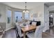 Bright dining room featuring hardwood floors, neutral walls, and a large window overlooking the front yard at 10167 Nadine Ave, Parker, CO 80134