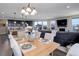 Dining room with a view of the modern kitchen and the cozy living space with a fireplace at 10167 Nadine Ave, Parker, CO 80134