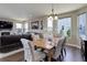 Stylish dining room with wood floors, table set for six, and a view into the cozy living room area at 10167 Nadine Ave, Parker, CO 80134