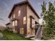 Exterior elevation showcasing the multi-story design and landscaping at 10167 Nadine Ave, Parker, CO 80134