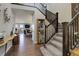 Grand foyer showcases a sweeping staircase, hardwood floors, and an open floor plan flowing into the living room at 10167 Nadine Ave, Parker, CO 80134
