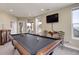 Open game room includes a pool table, mounted TV, and seating at 10167 Nadine Ave, Parker, CO 80134