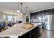 Open-concept kitchen features dark cabinetry, stainless steel appliances, and a large island with granite countertops at 10167 Nadine Ave, Parker, CO 80134