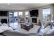 Bright living room boasts a fireplace, large windows, and a seamless transition to the outdoor deck at 10167 Nadine Ave, Parker, CO 80134