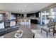 Open-concept living room and kitchen with dark wood floors and a seamless flow to the outdoor patio at 10167 Nadine Ave, Parker, CO 80134
