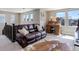 Comfortable living room with a leather couch, wooden desk, and lots of natural light at 10167 Nadine Ave, Parker, CO 80134