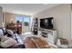 Spacious living area with stylish furnishings, a TV, and an abundance of natural light at 10167 Nadine Ave, Parker, CO 80134