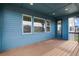 Relaxing back deck with wood floor, blue ceiling, and glass door leading to home interior at 8609 Cheraw St, Littleton, CO 80125