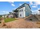 A view of the home's backyard with gravel, a small patch of grass and a hillside at 8609 Cheraw St, Littleton, CO 80125