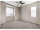 Neutral bedroom with carpet, ceiling fan, and two windows letting in natural light at 8609 Cheraw St, Littleton, CO 80125