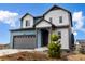 Charming two-story home exterior featuring blue and white siding and a two-car garage at 8609 Cheraw St, Littleton, CO 80125