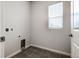 Clean laundry room with tile flooring, utility connections, and a bright window at 8609 Cheraw St, Littleton, CO 80125