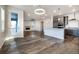 Open concept living space with hardwood flooring, a modern kitchen and a cozy fireplace at 8609 Cheraw St, Littleton, CO 80125